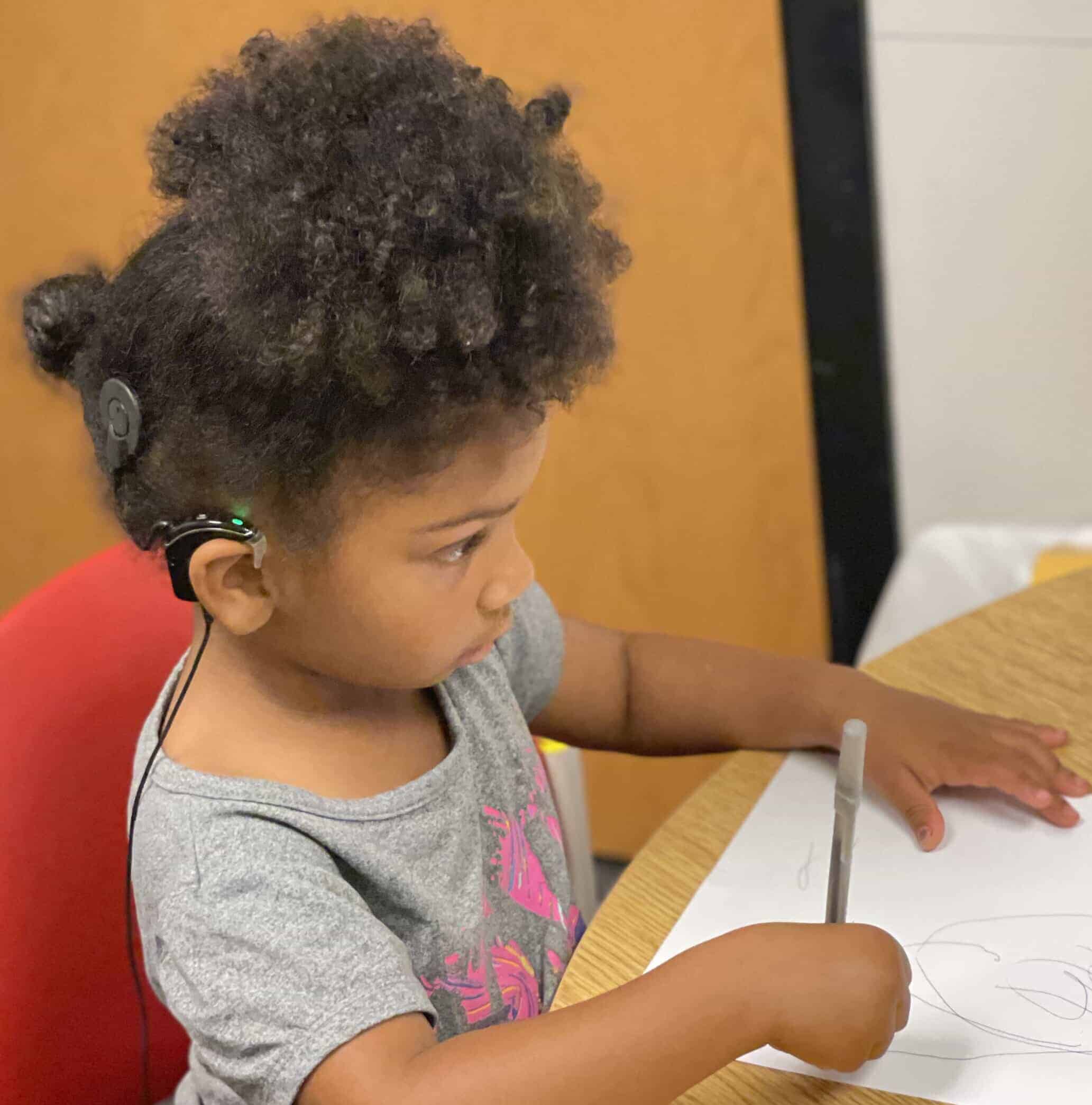 little girl with hearing device